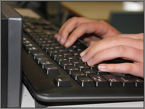 hands typing on the keyboard